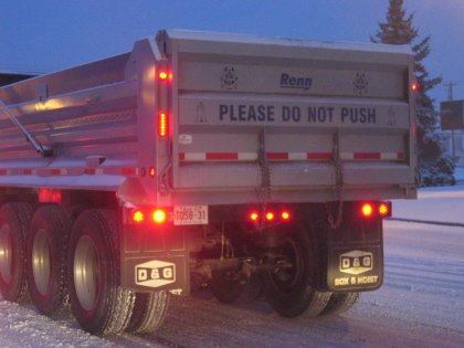 Sign on a dump truck in Calgary: 'Please Do Not Push'