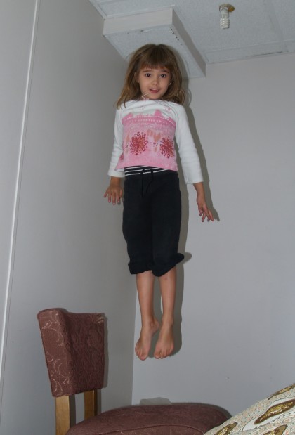 Maddy Hovering Above a Chair