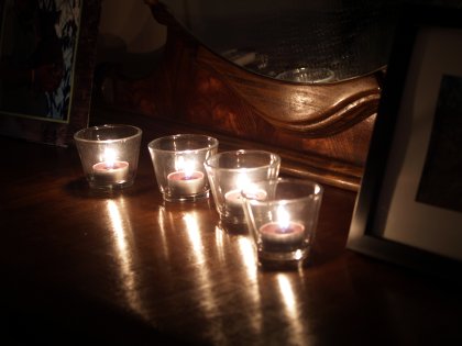 Four candles on a dresser