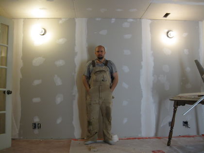 John amidst the plaster'd wall in his basement