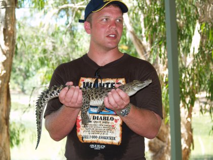 Bo holding a baby crocodile