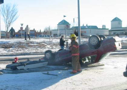 Car upside down on the
side of Crowchild Trail